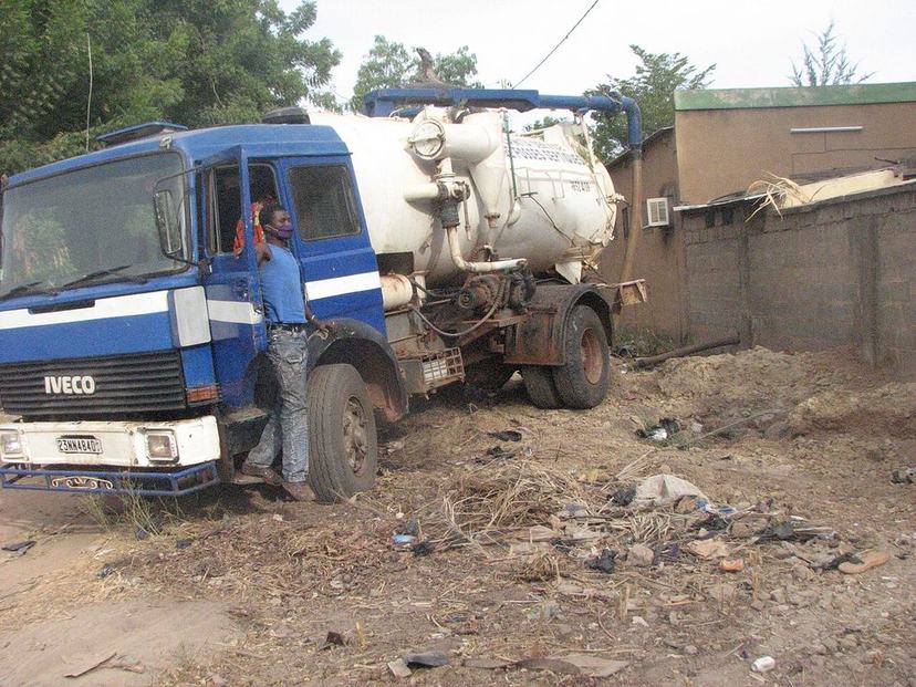 Crew pumping a tank with a vacuum truck